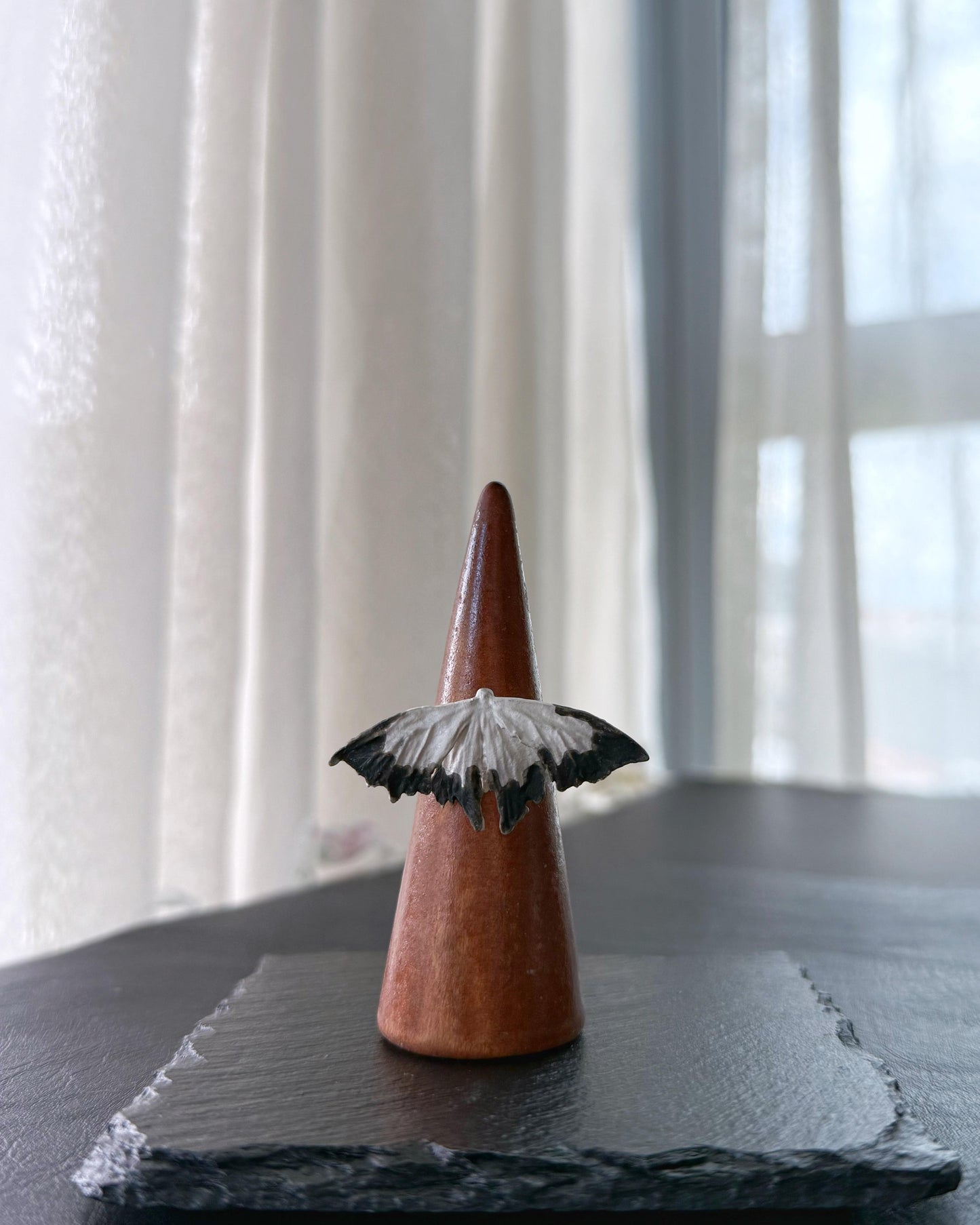 Detail of black and white moth wings jewelry