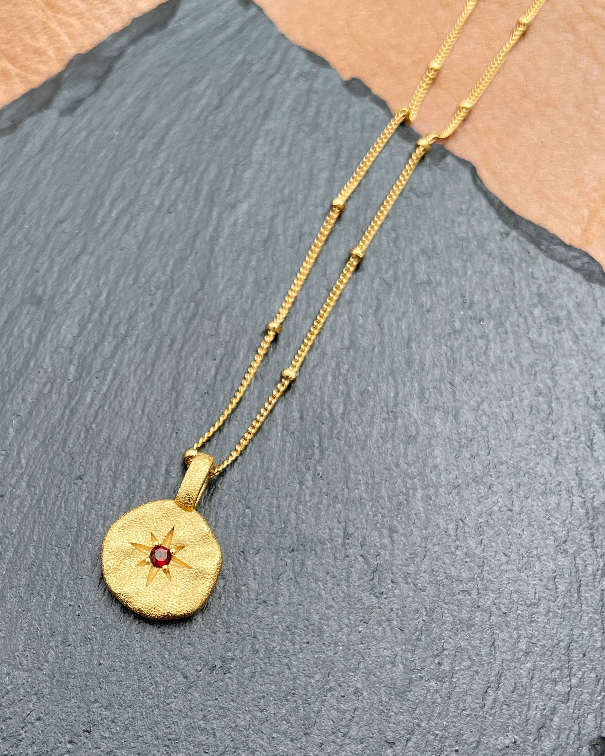 Gold hammered pendant with star engraving and red stone – Starseer Amulet Necklace by Refla