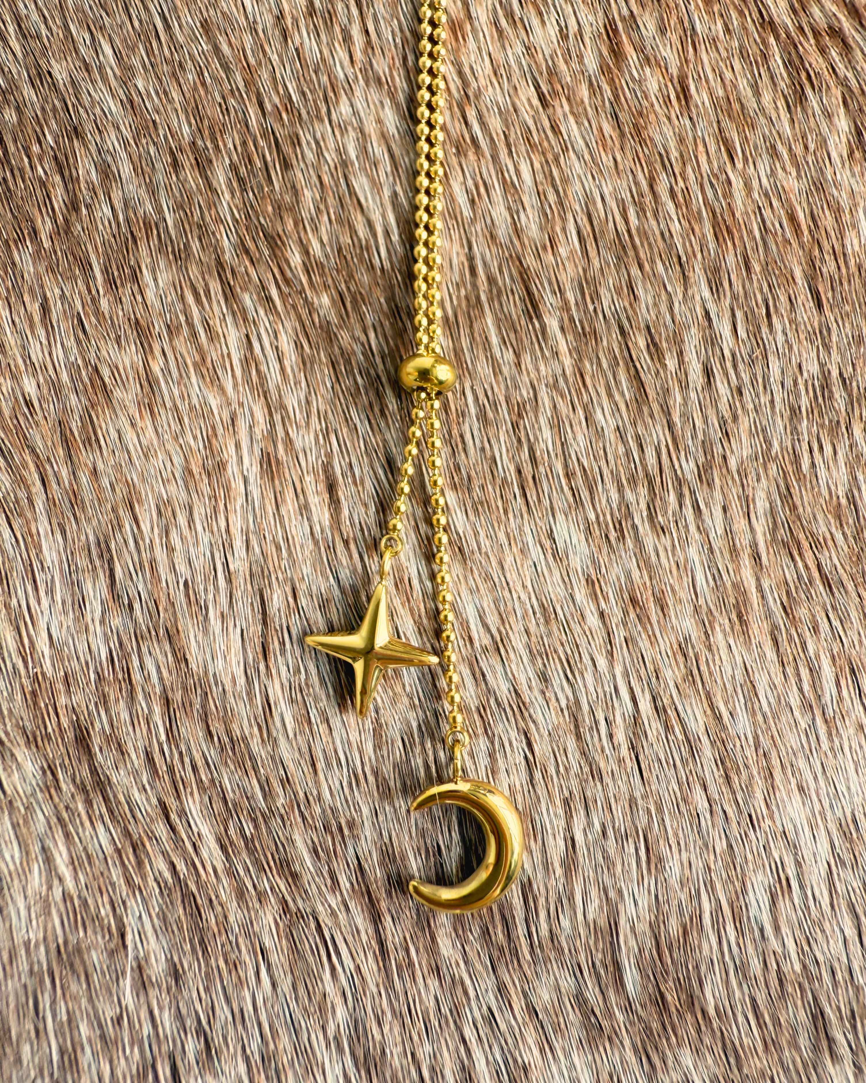 Delicate gold celestial necklace with crescent moon charm