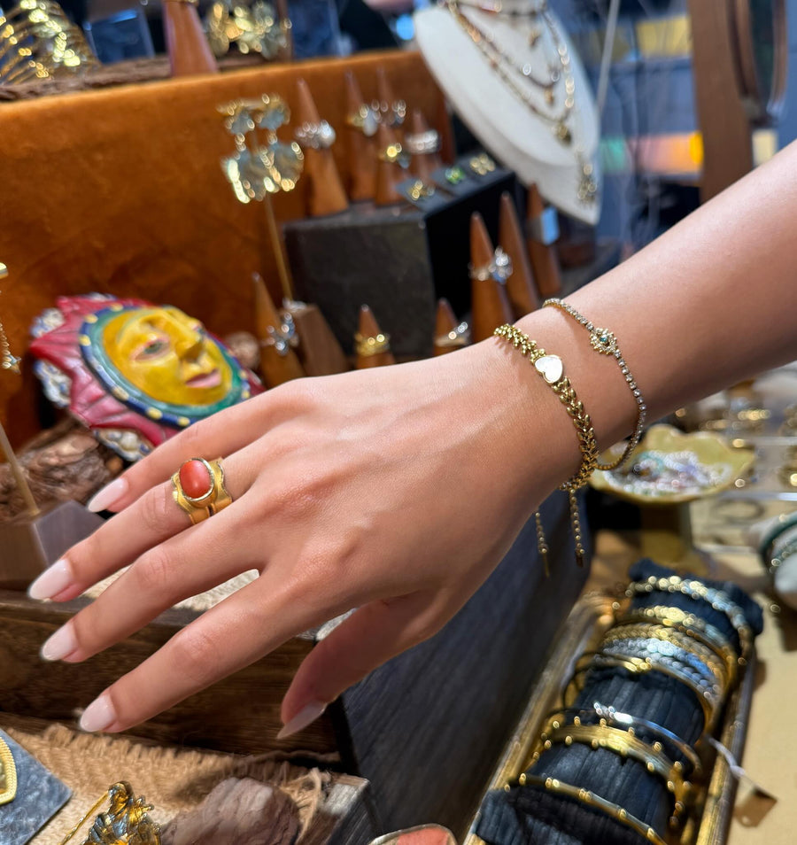 Layered ReflA bracelets and rings at a pop-up